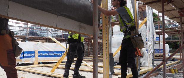 Prefabricated wooden trusses being installed on site